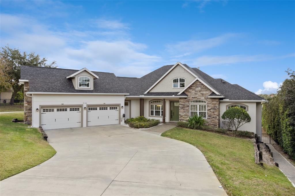 9126 Lake Coventry Court Gotha, FL 34734 - Photo 3 of 99 a front view of a house with a yard and garage