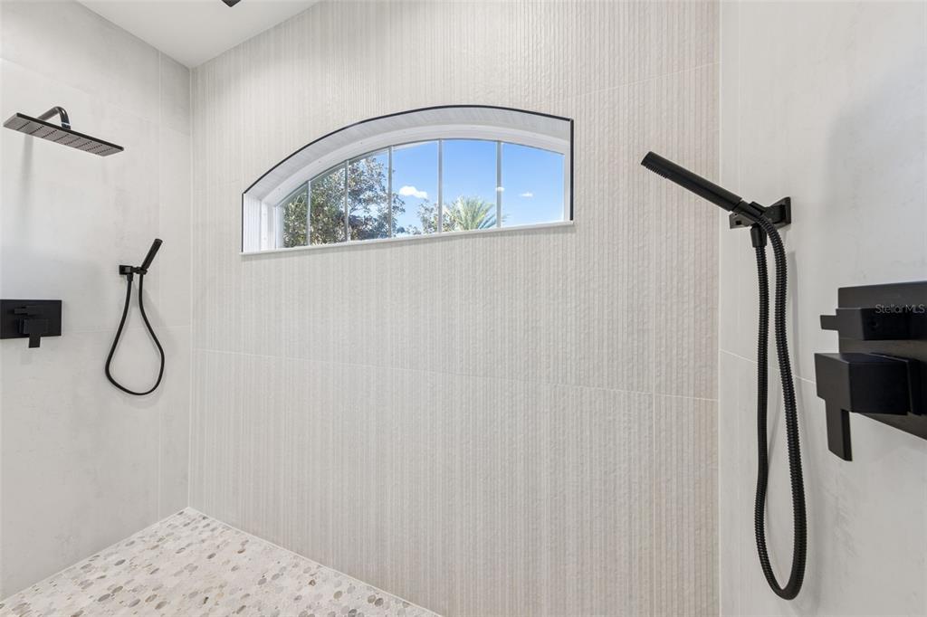 9126 Lake Coventry Court Gotha, FL 34734 - Photo 32 of 75 a bathroom with a glass shower door