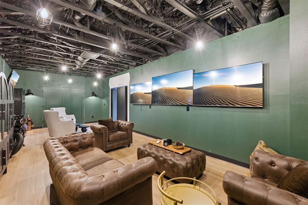 9126 Lake Coventry Court Gotha, FL 34734 - Photo 36 of 75 a projector room with a couch and a chandelier