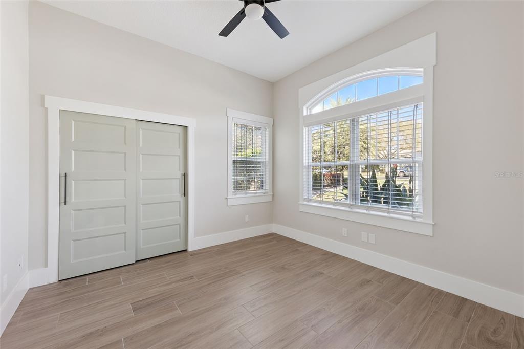 9126 Lake Coventry Court Gotha, FL 34734 - Photo 38 of 99 an empty room with wooden floor cabinet and windows
