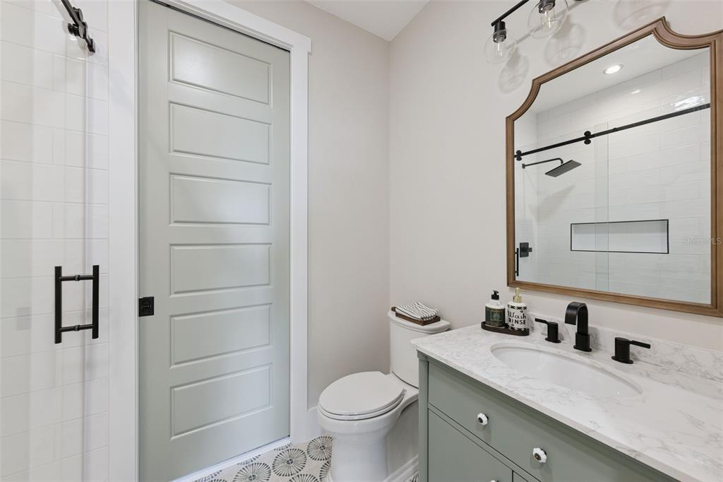 9126 Lake Coventry Court Gotha, FL 34734 - Photo 39 of 99 a bathroom with a granite countertop sink toilet and shower