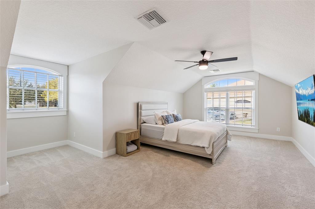 9126 Lake Coventry Court Gotha, FL 34734 - Photo 43 of 75 a spacious bedroom with a bed and a window
