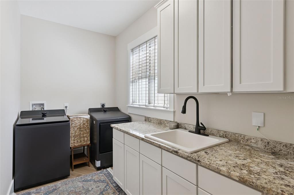 9126 Lake Coventry Court Gotha, FL 34734 - Photo 46 of 99 a kitchen with stainless steel appliances granite countertop a sink stove and refrigerator
