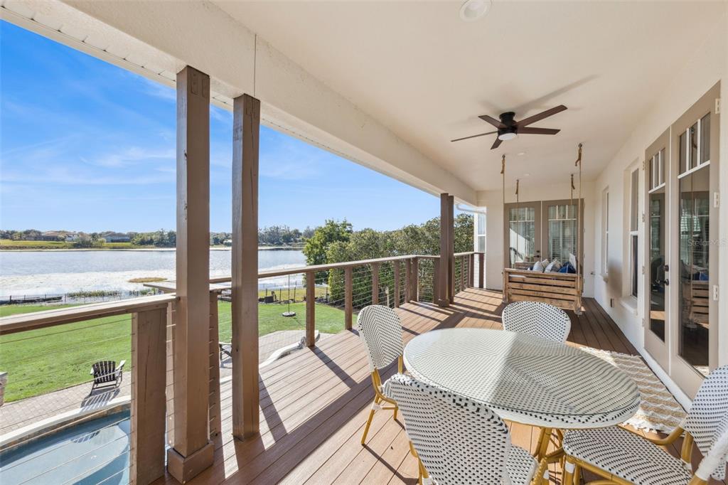 9126 Lake Coventry Court Gotha, FL 34734 - Photo 46 of 75 a balcony with furniture and a floor to ceiling window