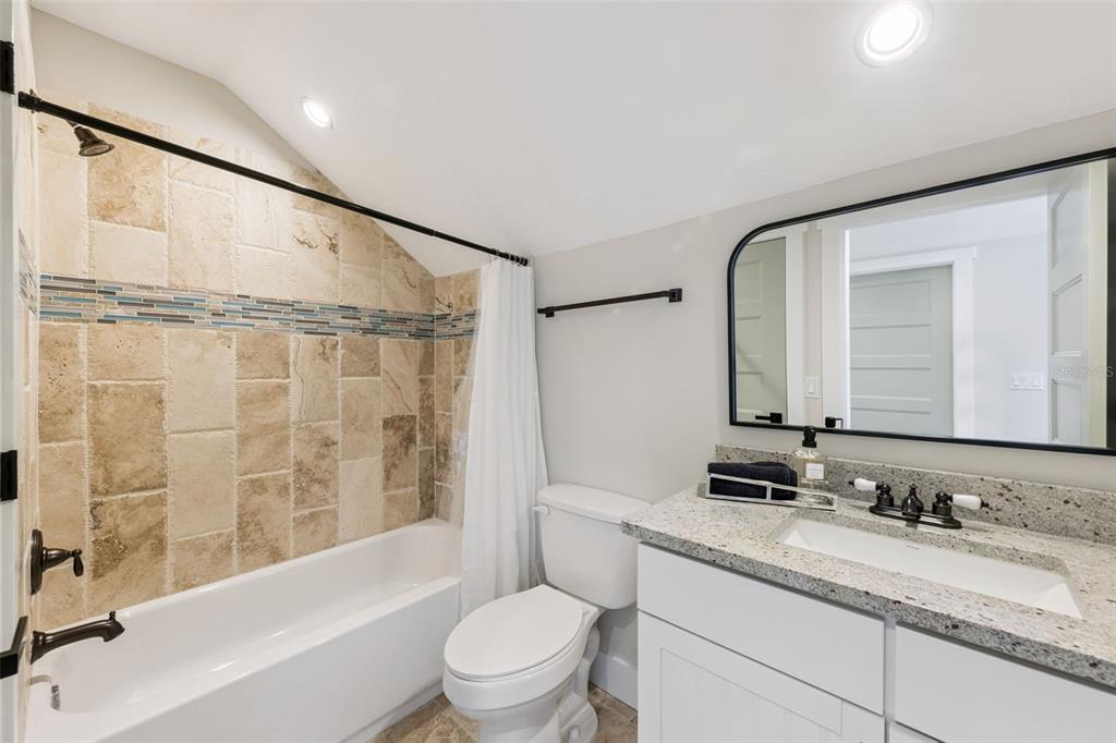 9126 Lake Coventry Court Gotha, FL 34734 - Photo 55 of 75 a bathroom with a granite countertop sink toilet and shower