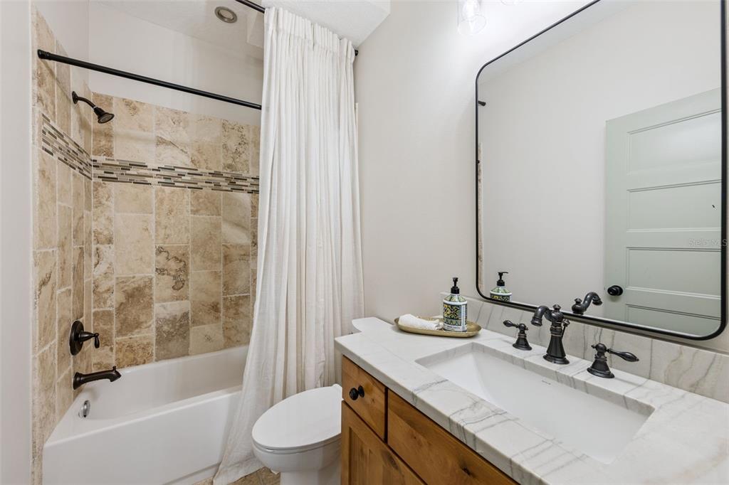 9126 Lake Coventry Court Gotha, FL 34734 - Photo 58 of 99 a bathroom with a granite countertop sink toilet and shower