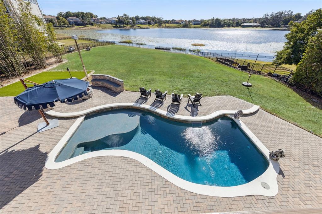 9126 Lake Coventry Court Gotha, FL 34734 - Photo 59 of 75 a view of a swimming pool and lounge chair