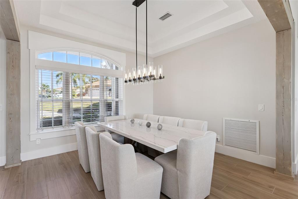 9126 Lake Coventry Court Gotha, FL 34734 - Photo 6 of 99 a view of a dining room with furniture wooden floor and chandelier