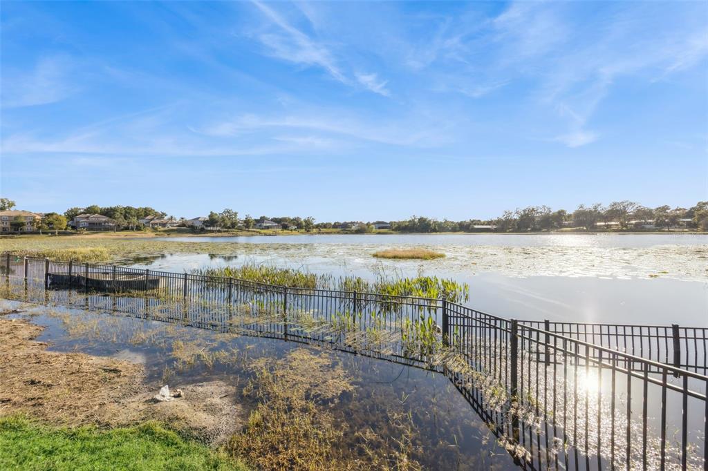 9126 Lake Coventry Court Gotha, FL 34734 - Photo 61 of 75 a view of a lake with houses in the background