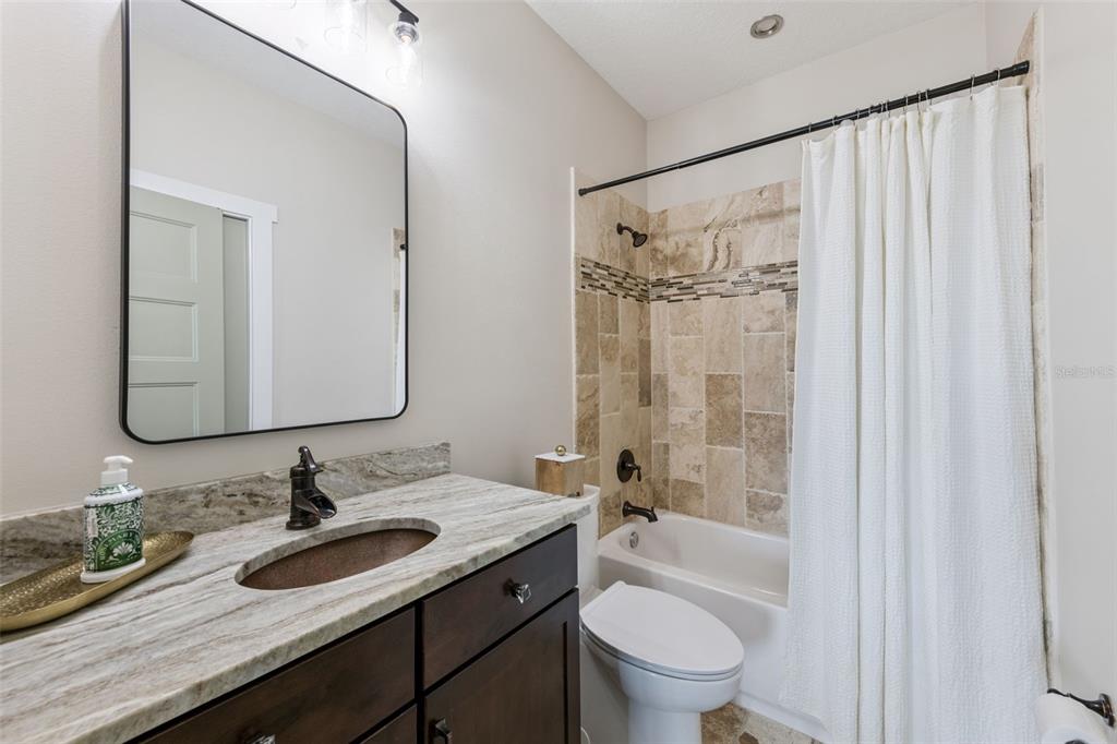 9126 Lake Coventry Court Gotha, FL 34734 - Photo 61 of 99 a bathroom with a granite countertop sink toilet and shower