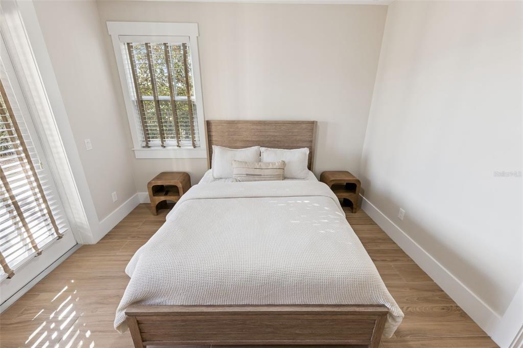 9126 Lake Coventry Court Gotha, FL 34734 - Photo 63 of 99 a bed sitting in a bedroom next to a window