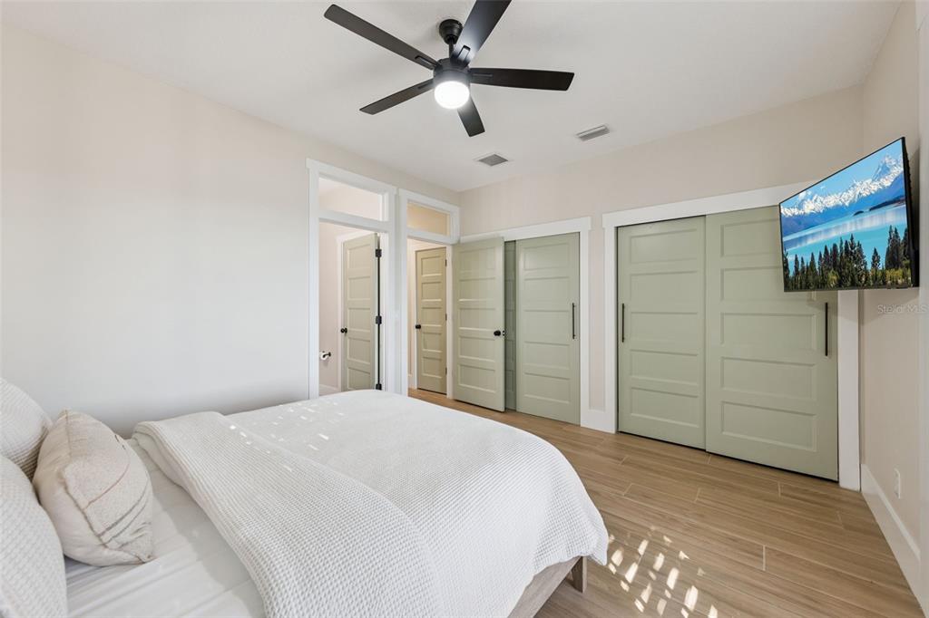 9126 Lake Coventry Court Gotha, FL 34734 - Photo 65 of 99 a bedroom with a bed and a flat screen tv