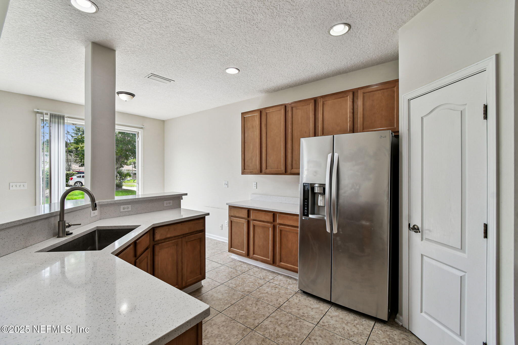 536 Spanish Wells Road Jacksonville, FL 32218 - Photo 12 of 45 a kitchen with stainless steel appliances granite countertop a sink a stove and a refrigerator