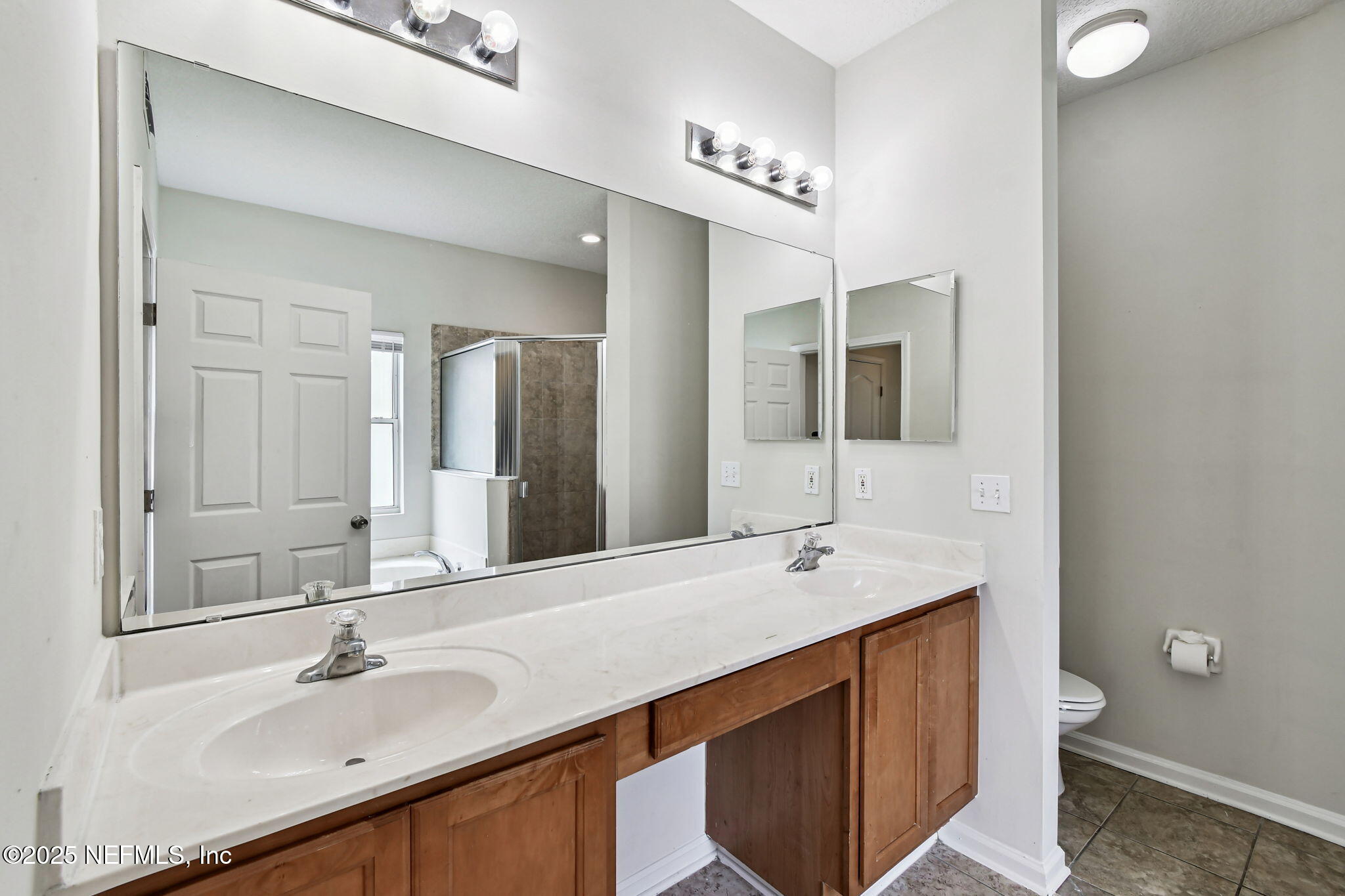 536 Spanish Wells Road Jacksonville, FL 32218 - Photo 19 of 45 a bathroom with a sink and a mirror