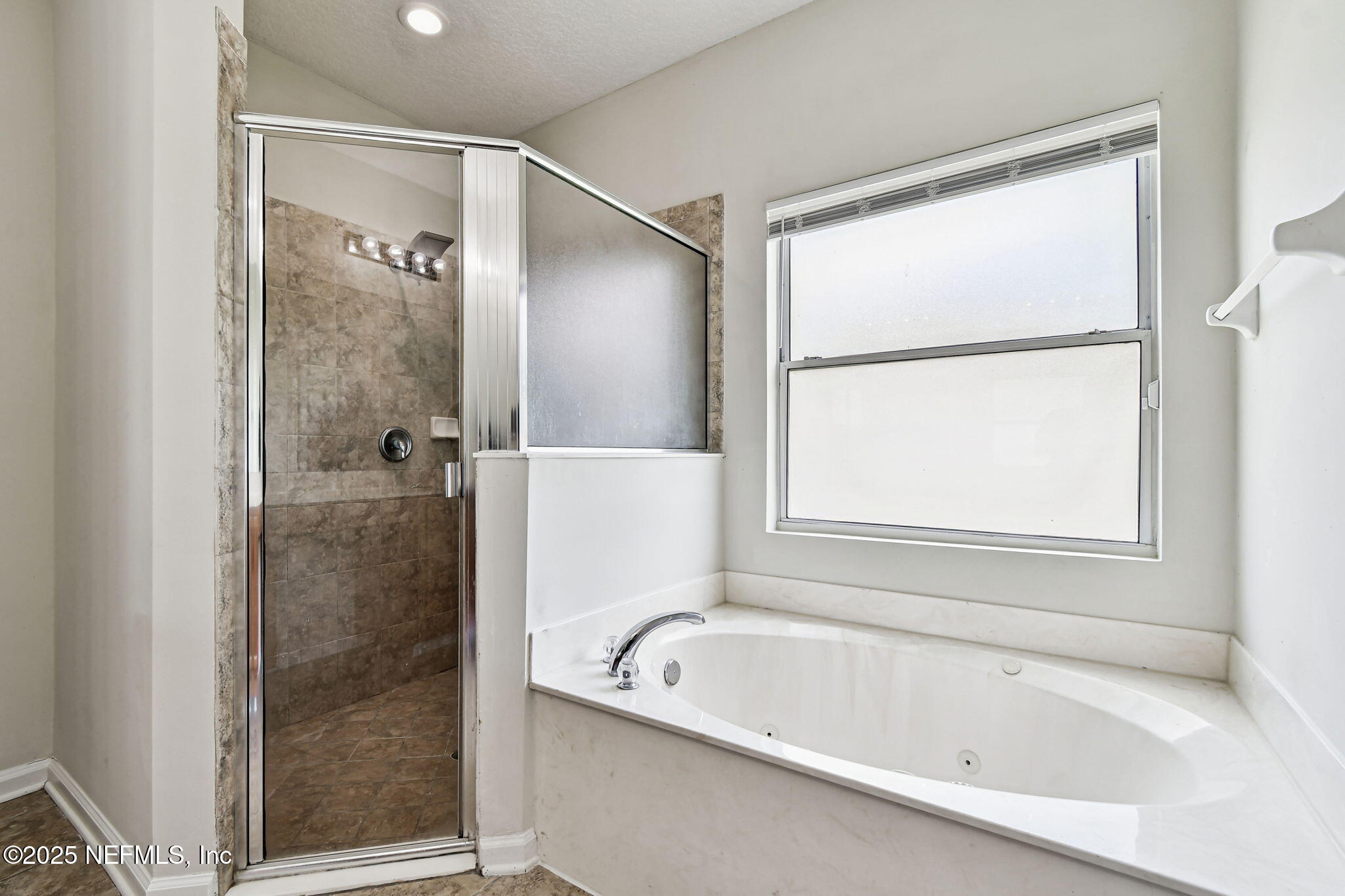 536 Spanish Wells Road Jacksonville, FL 32218 - Photo 20 of 45 a bathroom with a tub shower and window