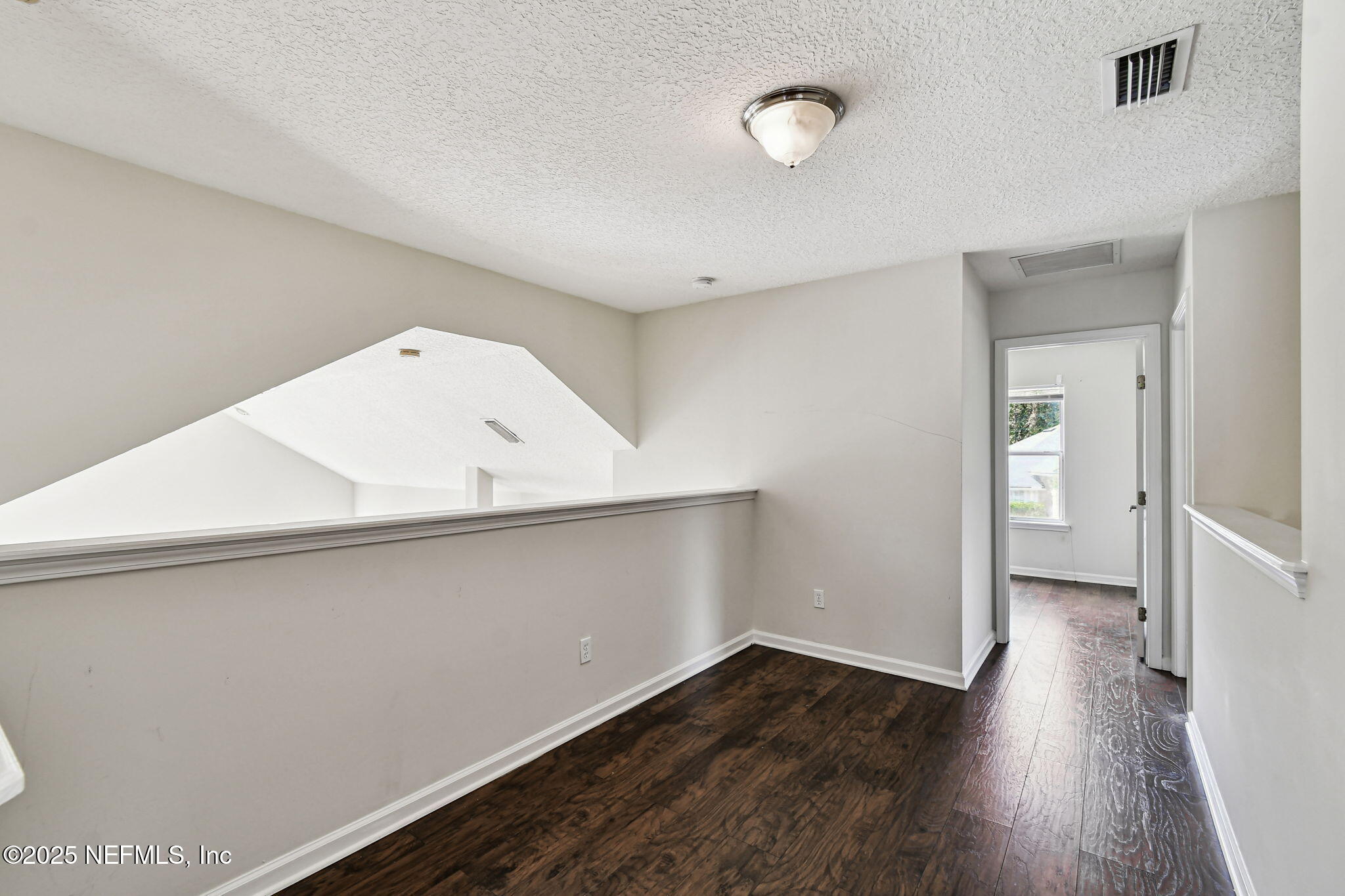 536 Spanish Wells Road Jacksonville, FL 32218 - Photo 21 of 45 a view of an empty room with wooden floor