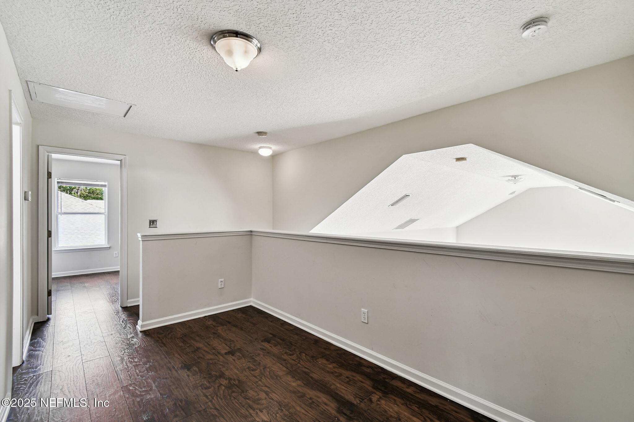 536 Spanish Wells Road Jacksonville, FL 32218 - Photo 22 of 45 a view of an empty room with wooden floor