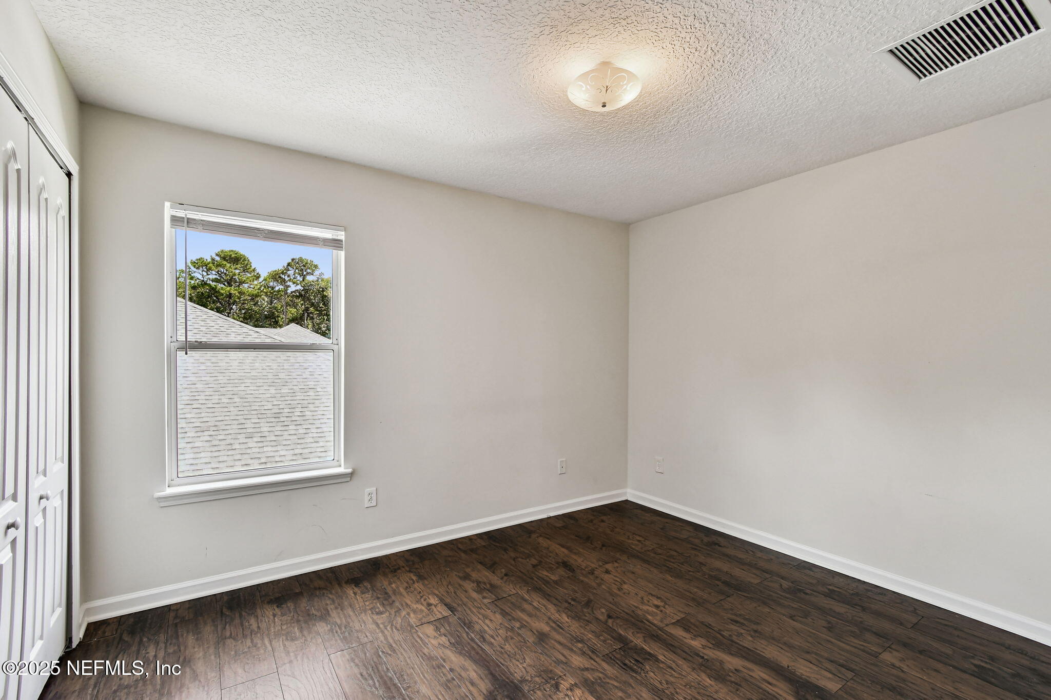 536 Spanish Wells Road Jacksonville, FL 32218 - Photo 23 of 45 an empty room with wooden floor and window