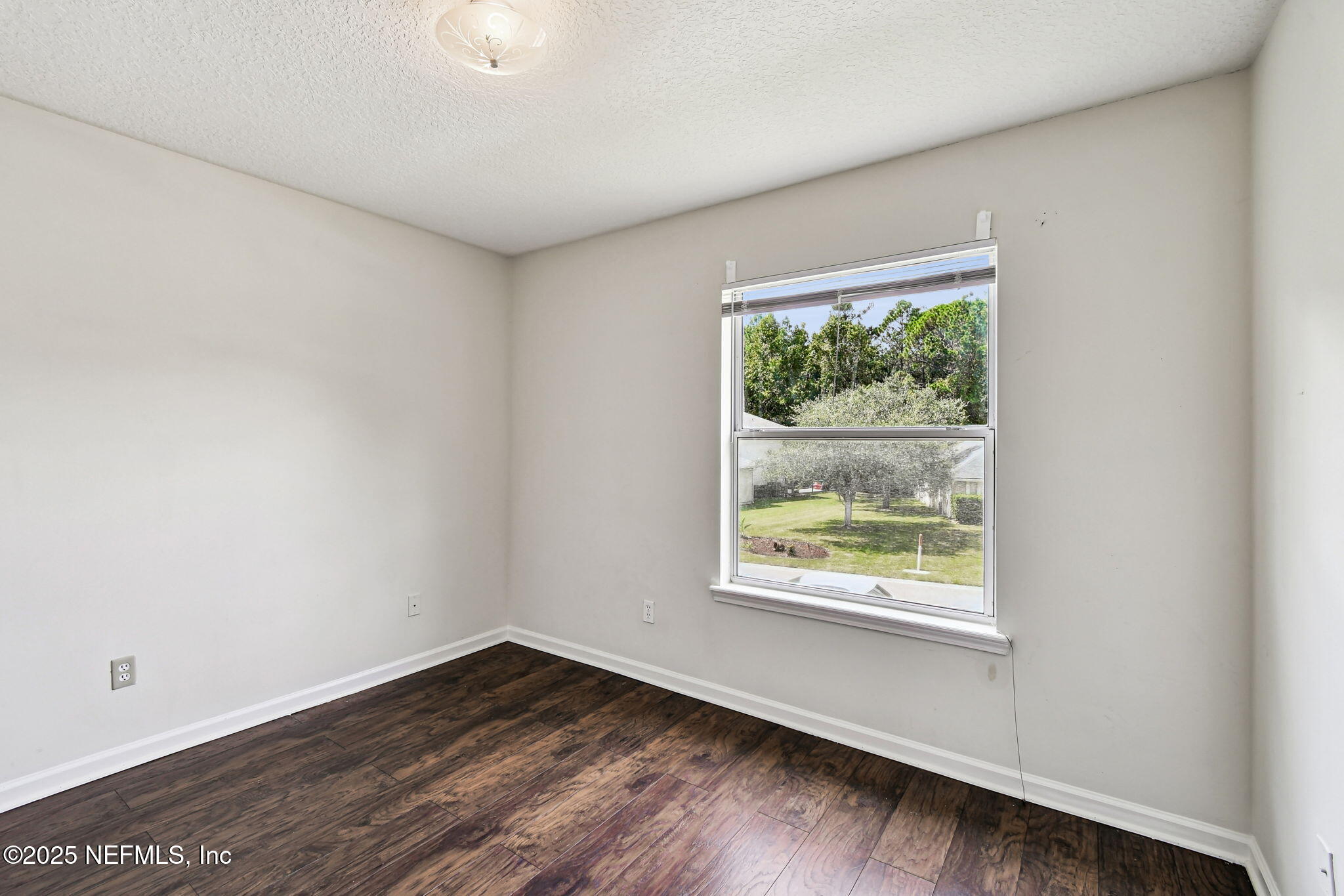 536 Spanish Wells Road Jacksonville, FL 32218 - Photo 29 of 45 an empty room with wooden floor and windows