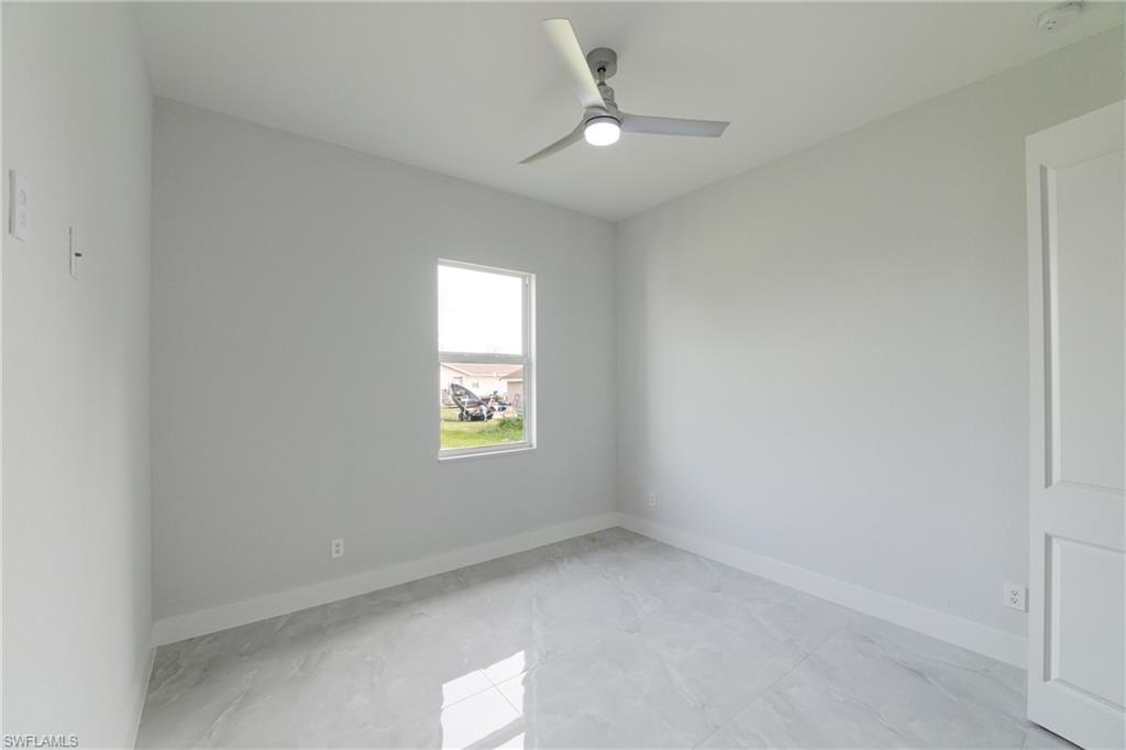 3408 12th Street Southwest Lehigh Acres, FL 33976 - Photo 11 of 47 an empty room with a window