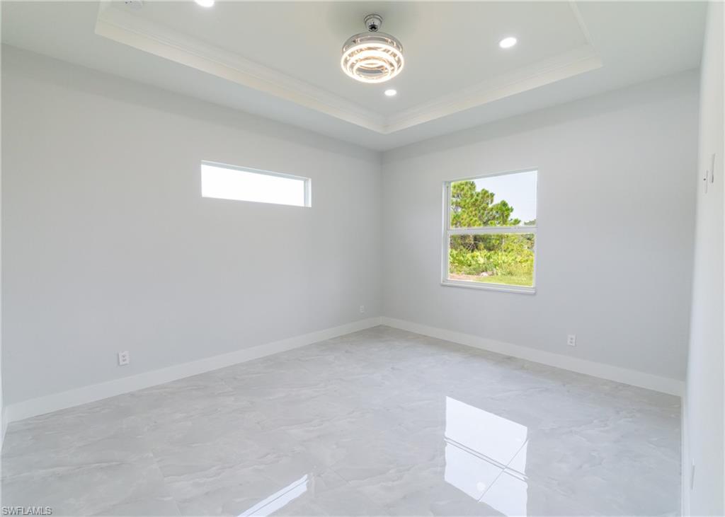 3408 12th Street Southwest Lehigh Acres, FL 33976 - Photo 13 of 47 an empty room with a window