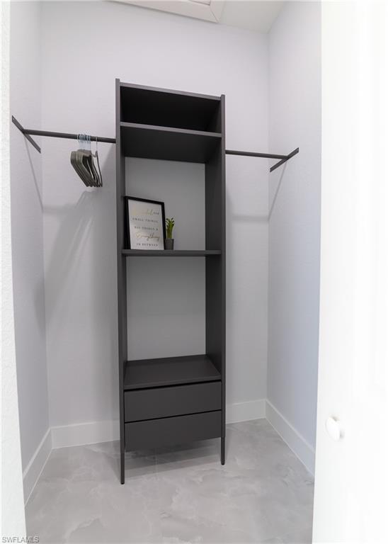 3408 12th Street Southwest Lehigh Acres, FL 33976 - Photo 18 of 47 a room with a bench and a cabinet