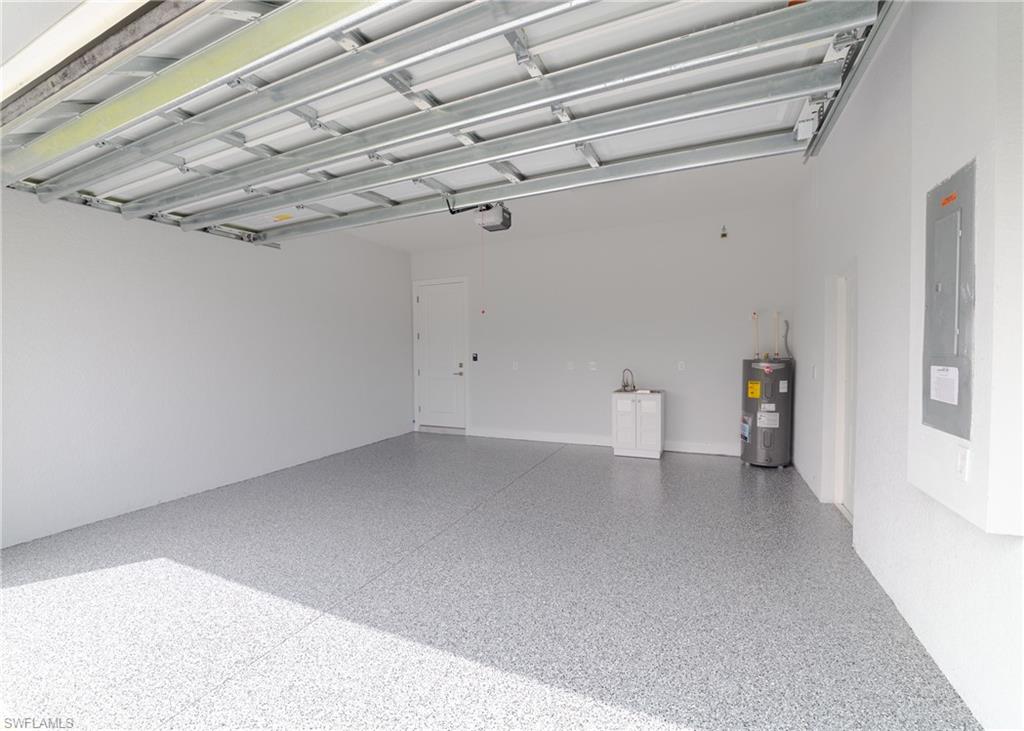 3408 12th Street Southwest Lehigh Acres, FL 33976 - Photo 36 of 47 a view of a room with racks on the wall