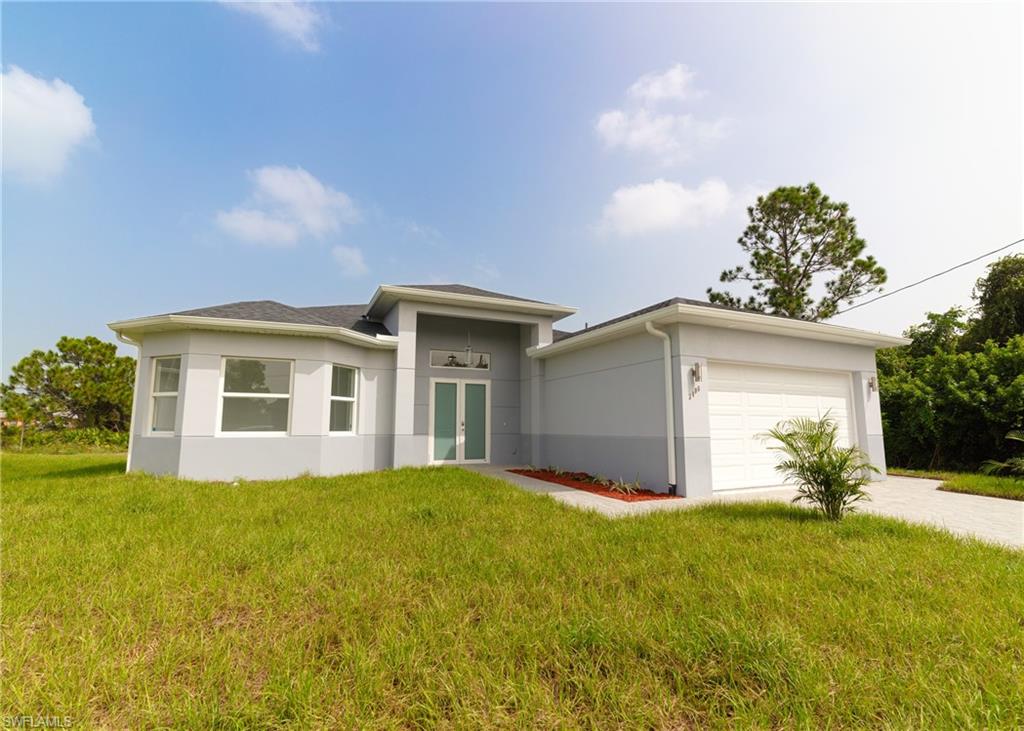 3408 12th Street Southwest Lehigh Acres, FL 33976 - Photo 38 of 47 a front view of house with yard and trees around