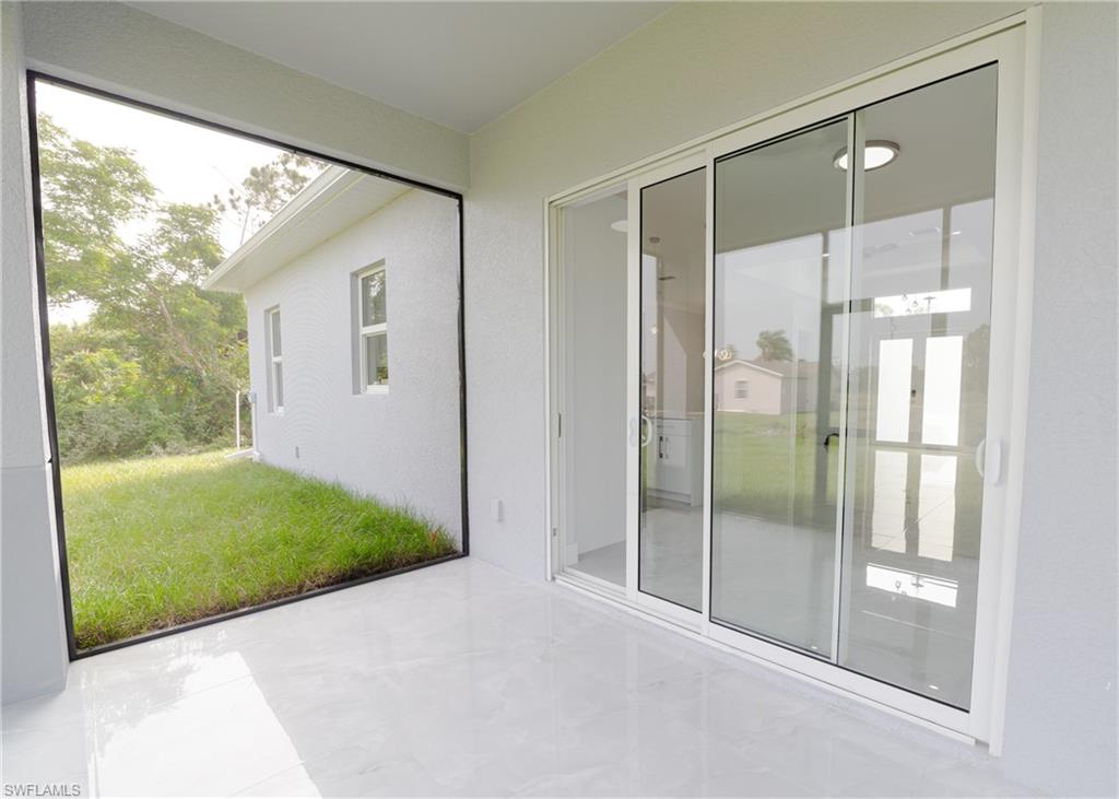 3408 12th Street Southwest Lehigh Acres, FL 33976 - Photo 40 of 47 a bathroom with a glass shower door and a sink