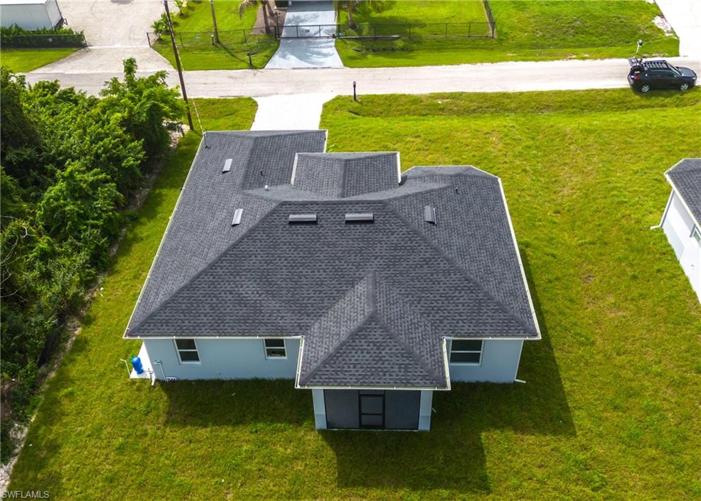 3408 12th Street Southwest Lehigh Acres, FL 33976 - Photo 42 of 47 an aerial view of a house with a garden and lake view