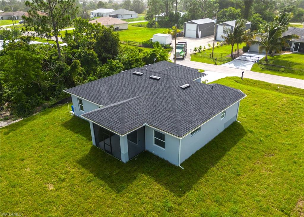 3408 12th Street Southwest Lehigh Acres, FL 33976 - Photo 43 of 47 an aerial view of a house with swimming pool garden and patio