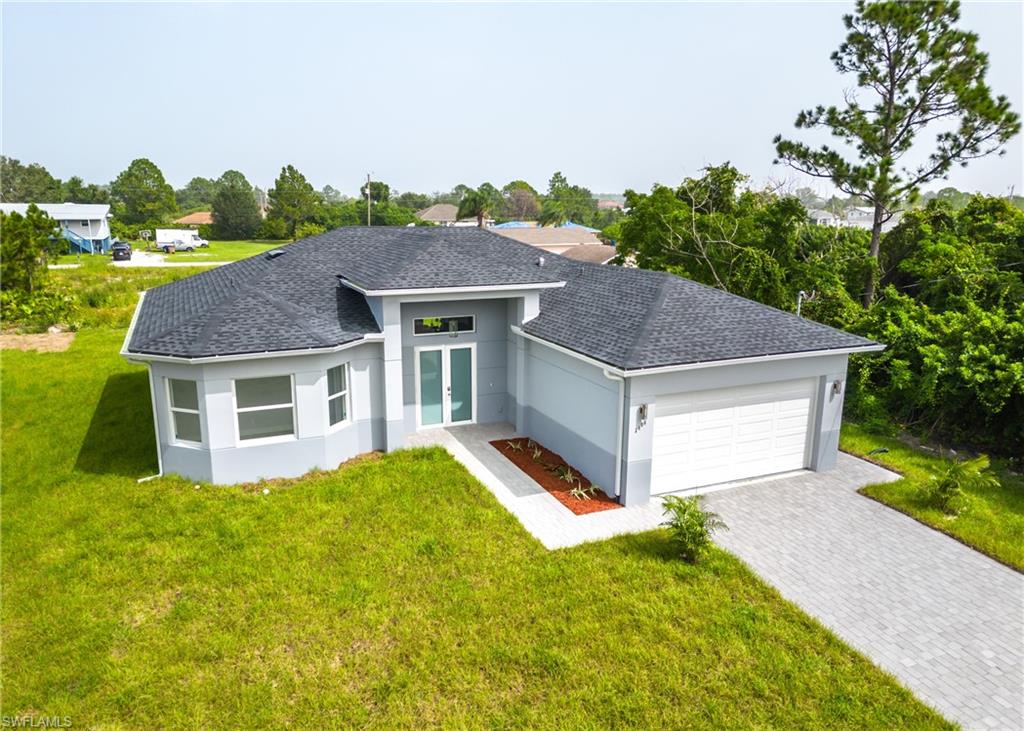 3408 12th Street Southwest Lehigh Acres, FL 33976 - Photo 44 of 47 a aerial view of a house with yard and plants
