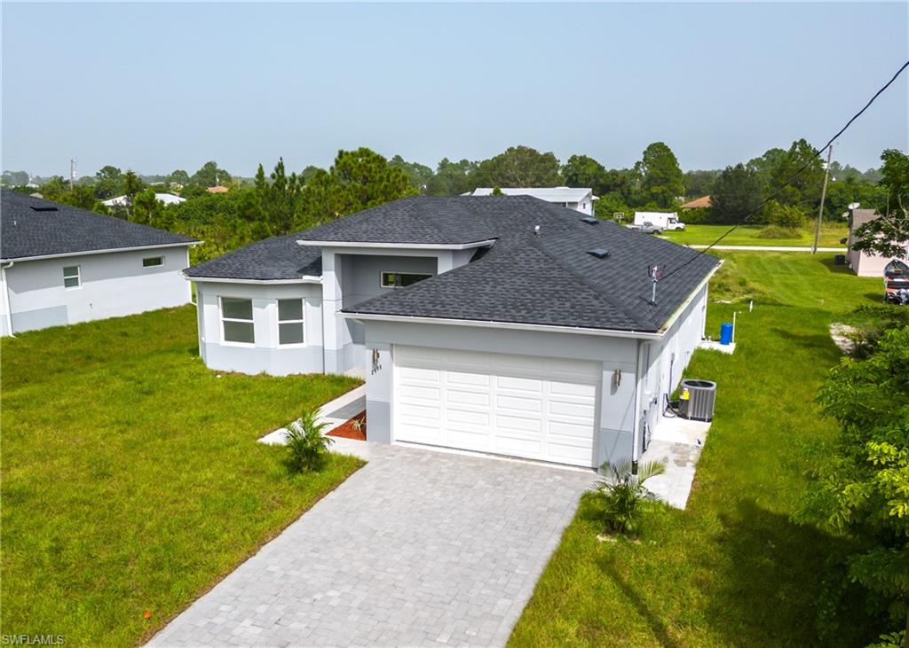 3408 12th Street Southwest Lehigh Acres, FL 33976 - Photo 47 of 47 a front view of a house with a yard