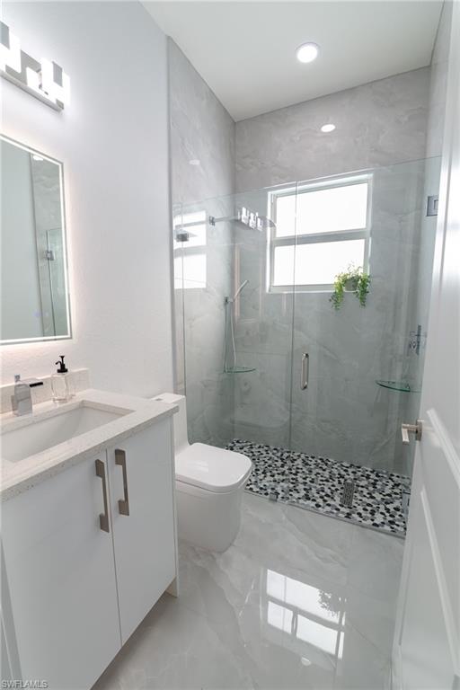 3408 12th Street Southwest Lehigh Acres, FL 33976 - Photo 7 of 47 a bathroom with a sink a toilet and shower