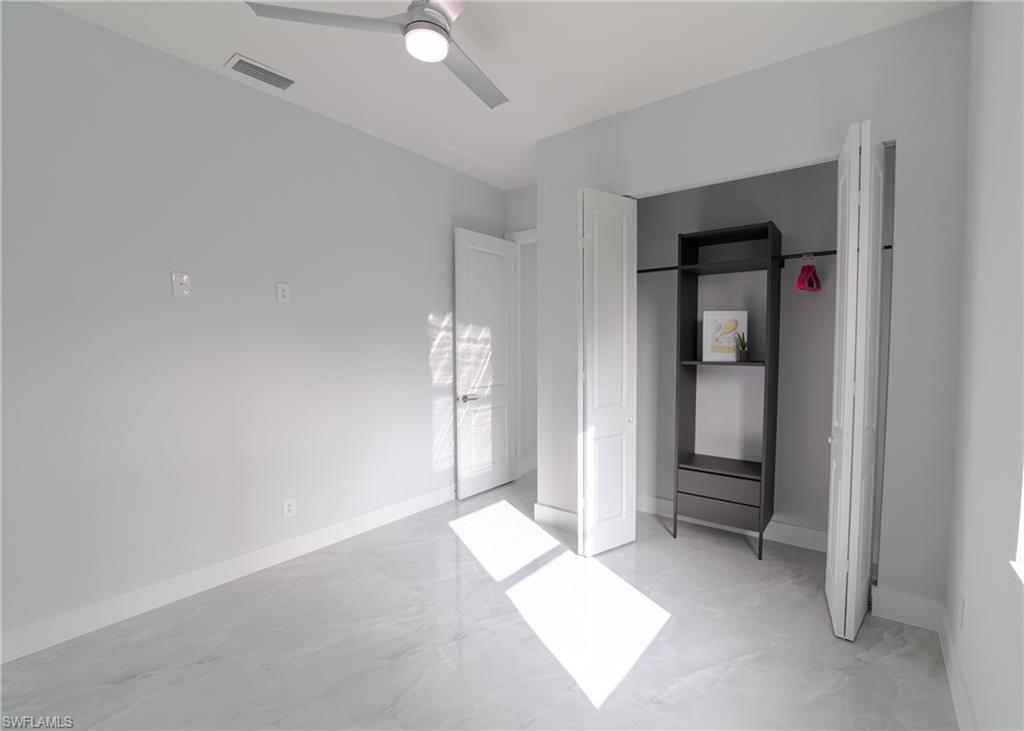 3408 12th Street Southwest Lehigh Acres, FL 33976 - Photo 8 of 47 an empty room with windows