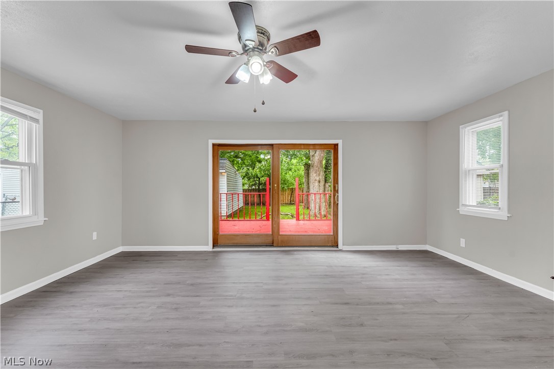 18517 Homeway Road Cleveland, OH 44135 - Photo 6 of 29 Spacious interior featuring wood-finish flooring, light grey painted walls, and a ceiling fan with integrated lighting