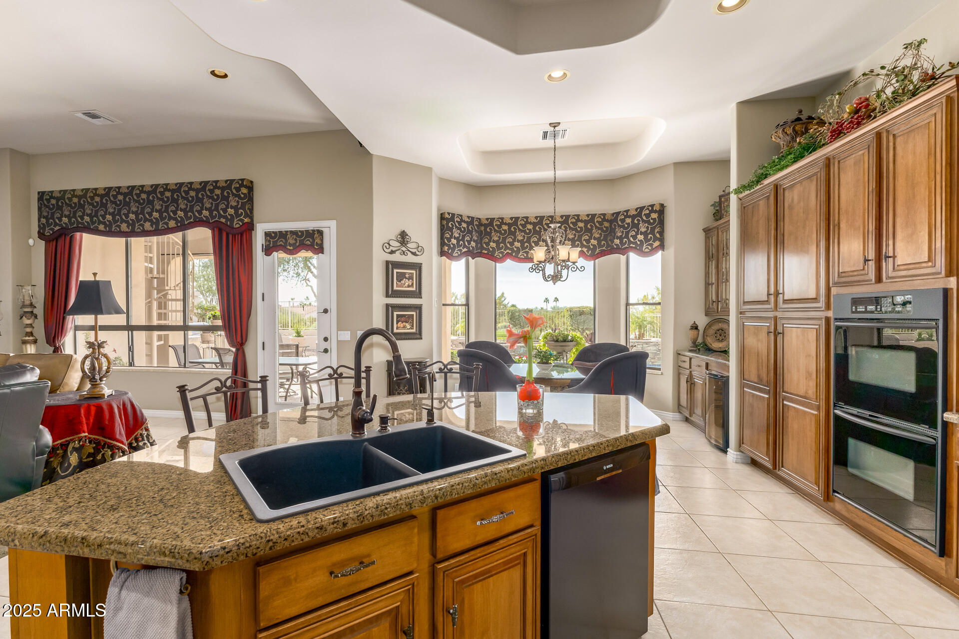 4055 North Recker Road Mesa, AZ 85215 - Photo 10 of 70 a kitchen with granite countertop a sink appliances and cabinets