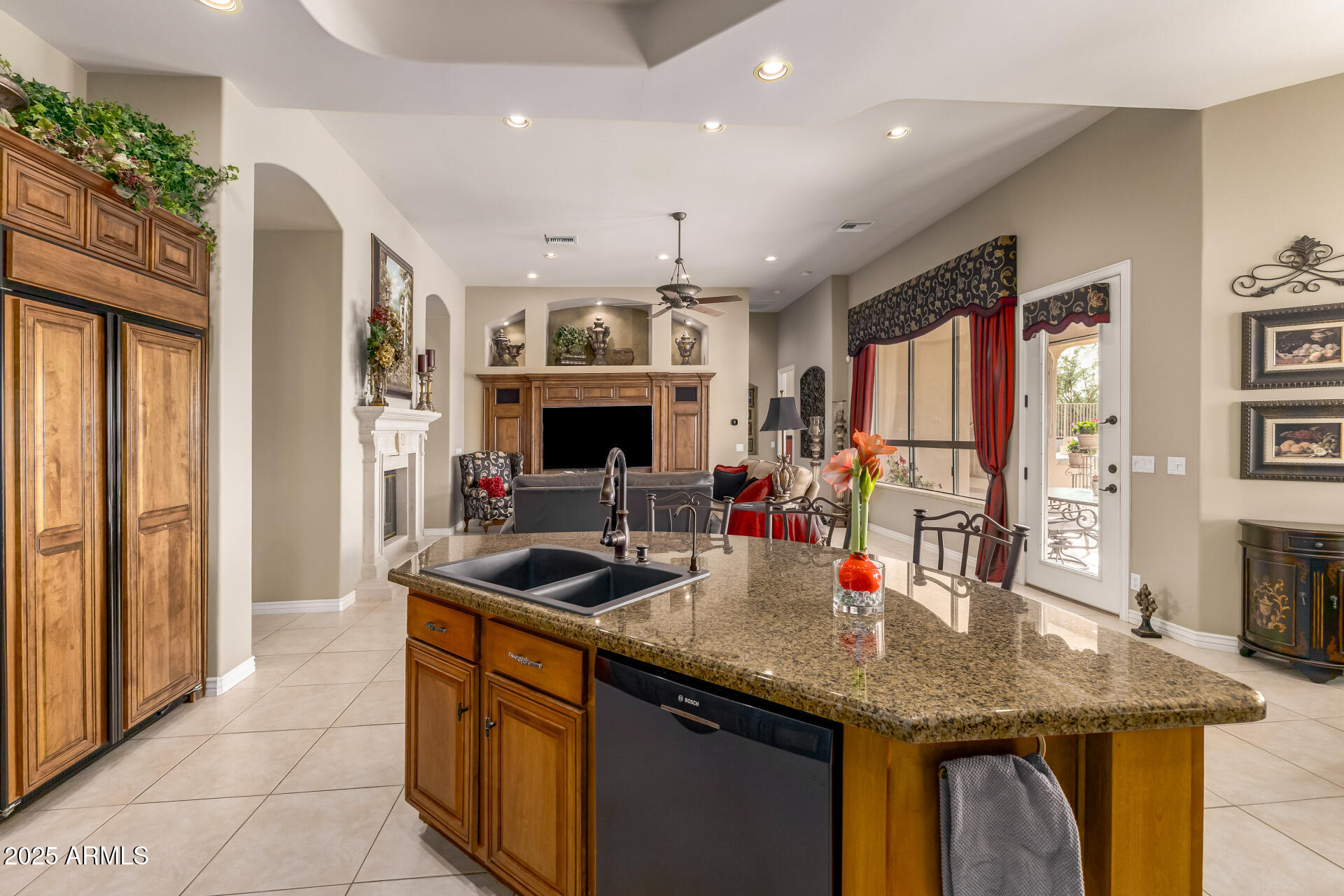 4055 North Recker Road Mesa, AZ 85215 - Photo 13 of 70 a kitchen with stainless steel appliances granite countertop a sink dishwasher and a refrigerator with wooden floor