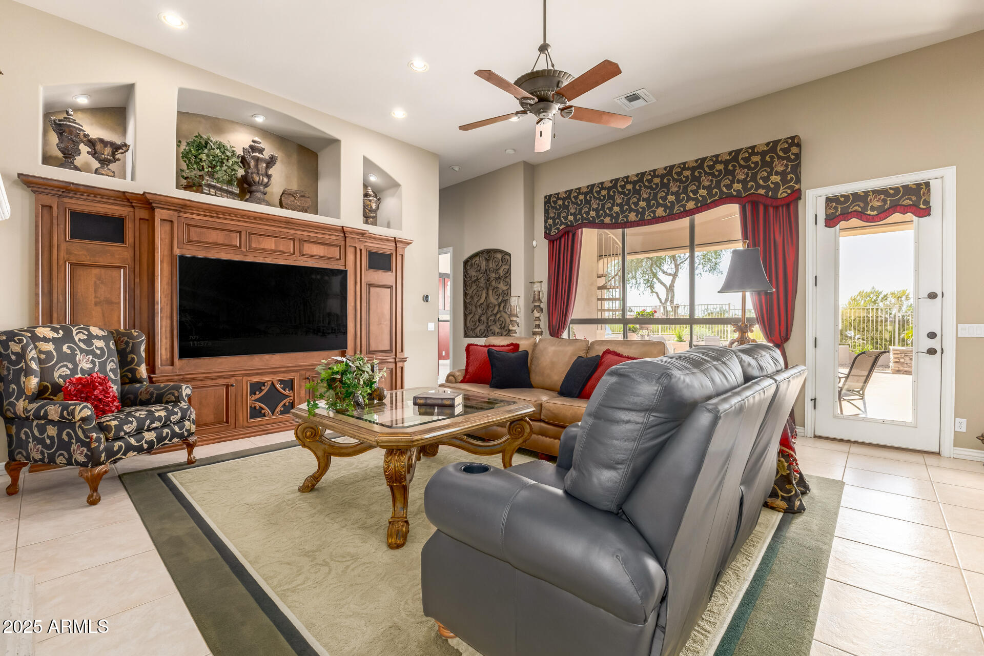 4055 North Recker Road Mesa, AZ 85215 - Photo 6 of 70 a living room with furniture a flat screen tv and a fireplace