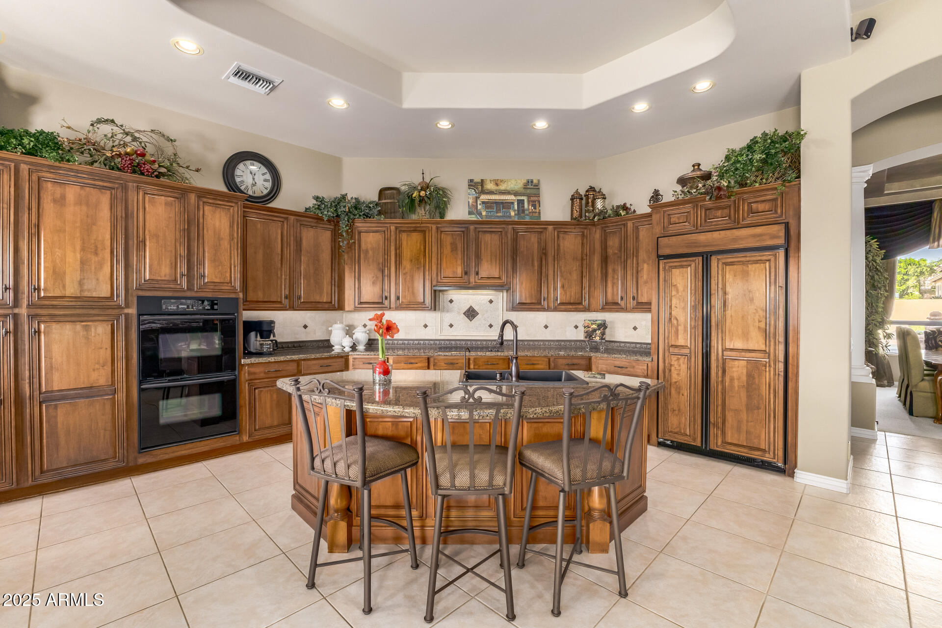 4055 North Recker Road Mesa, AZ 85215 - Photo 8 of 70 a dining hall with stainless steel appliances kitchen island granite countertop a refrigerator and cabinets