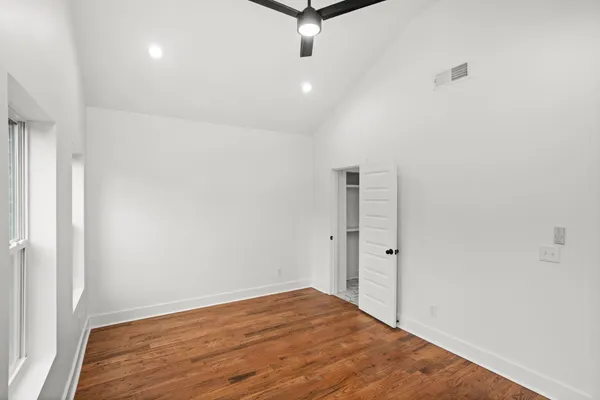 a view of a room with wooden floor and white walls