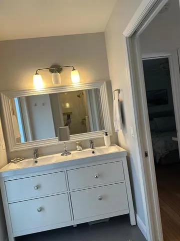 a bathroom with a double vanity sink and mirror