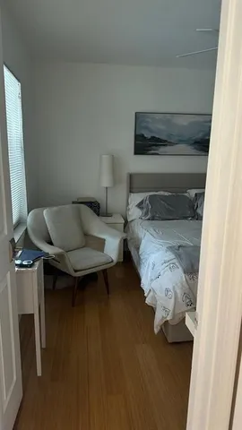 a bedroom with a bed and a potted plant on the table
