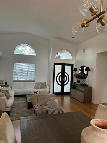 a living room with furniture a rug and a window