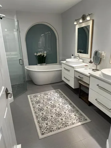a bathroom with a bathtub sink and mirror