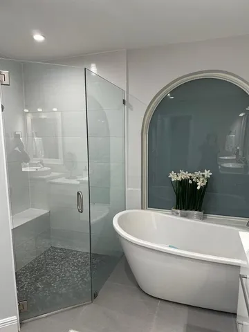 a bathroom with a bathtub and a shower
