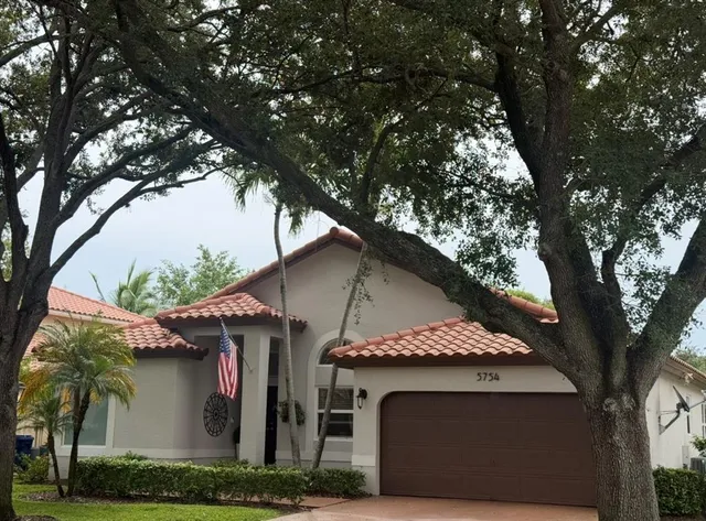 a view of a house with a tree