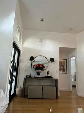 a living room with furniture and a mirror