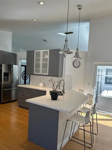 a kitchen with a table chairs and microwave