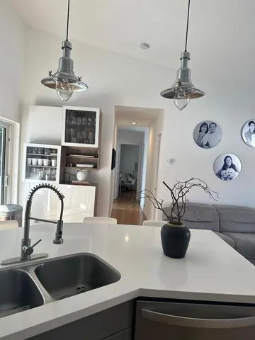 a kitchen with a sink and a refrigerator
